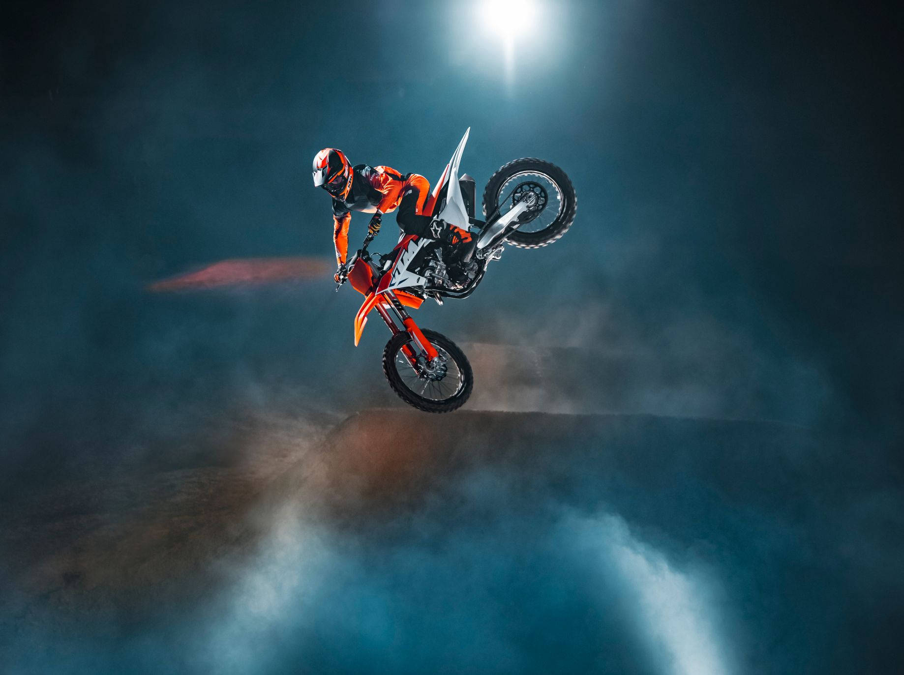 A Person Riding A Dirt Bike In The Dark Background