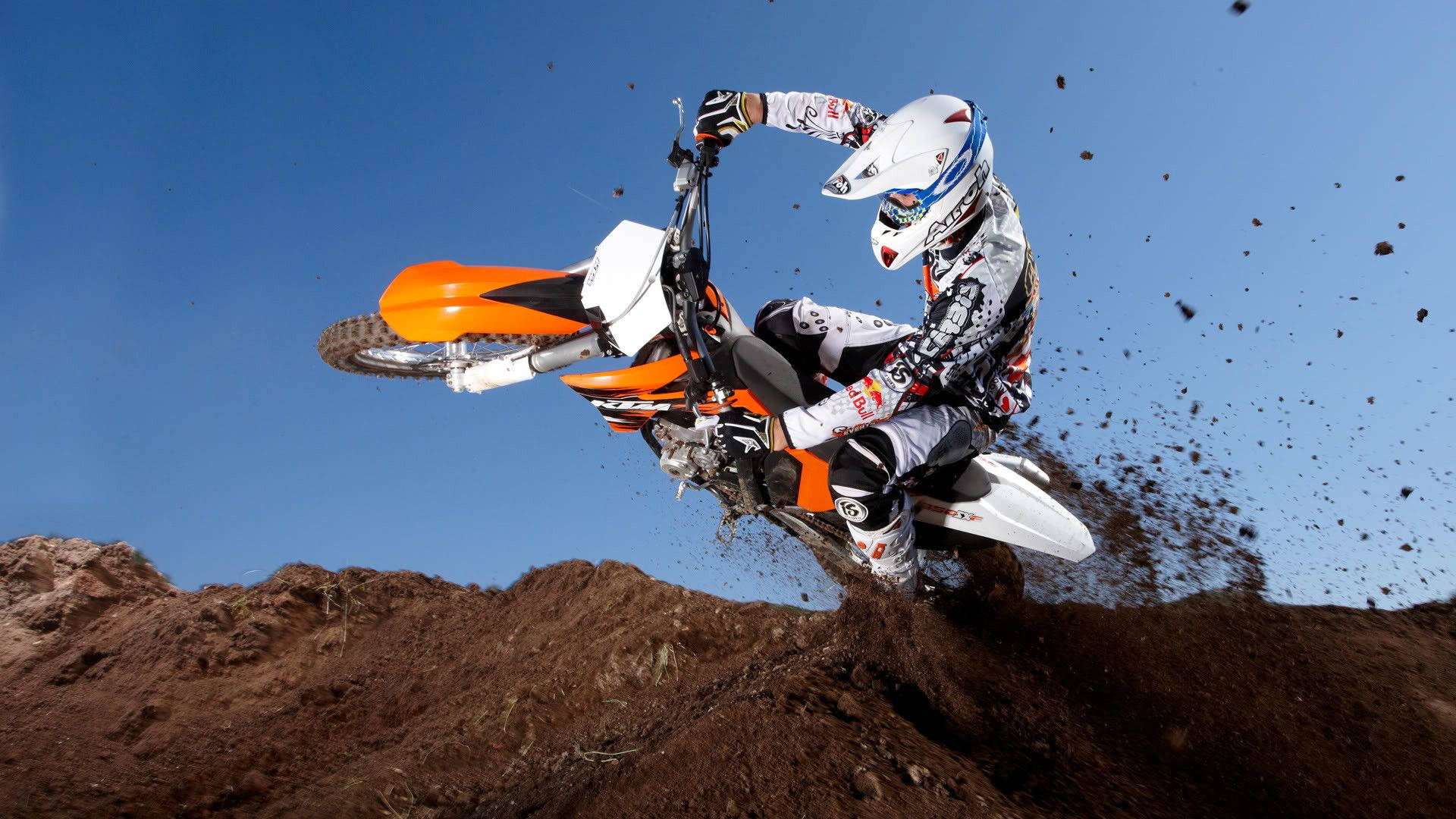 A Person Riding A Dirt Bike On A Dirt Track Background