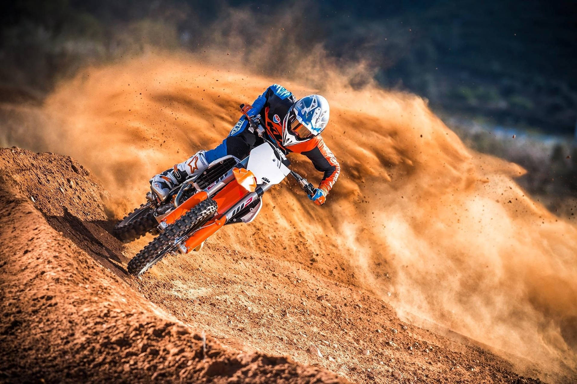 A Person Riding A Dirt Bike On A Dirt Track Background