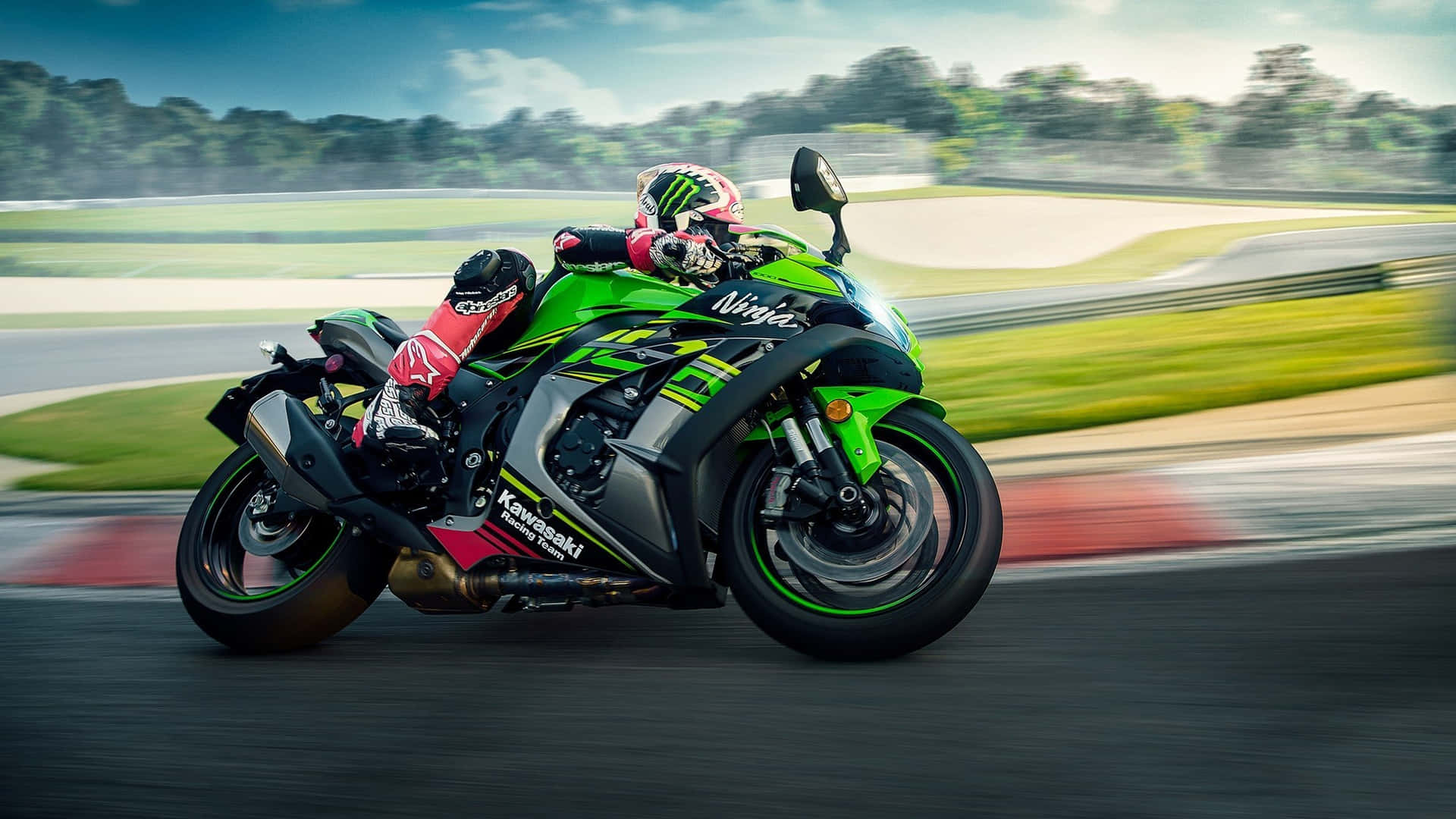 A Person Riding A Green Motorcycle On A Track Background