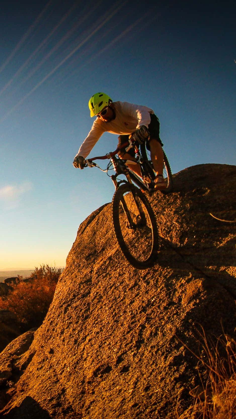 A Person Riding A Mountain Bike On A Rock