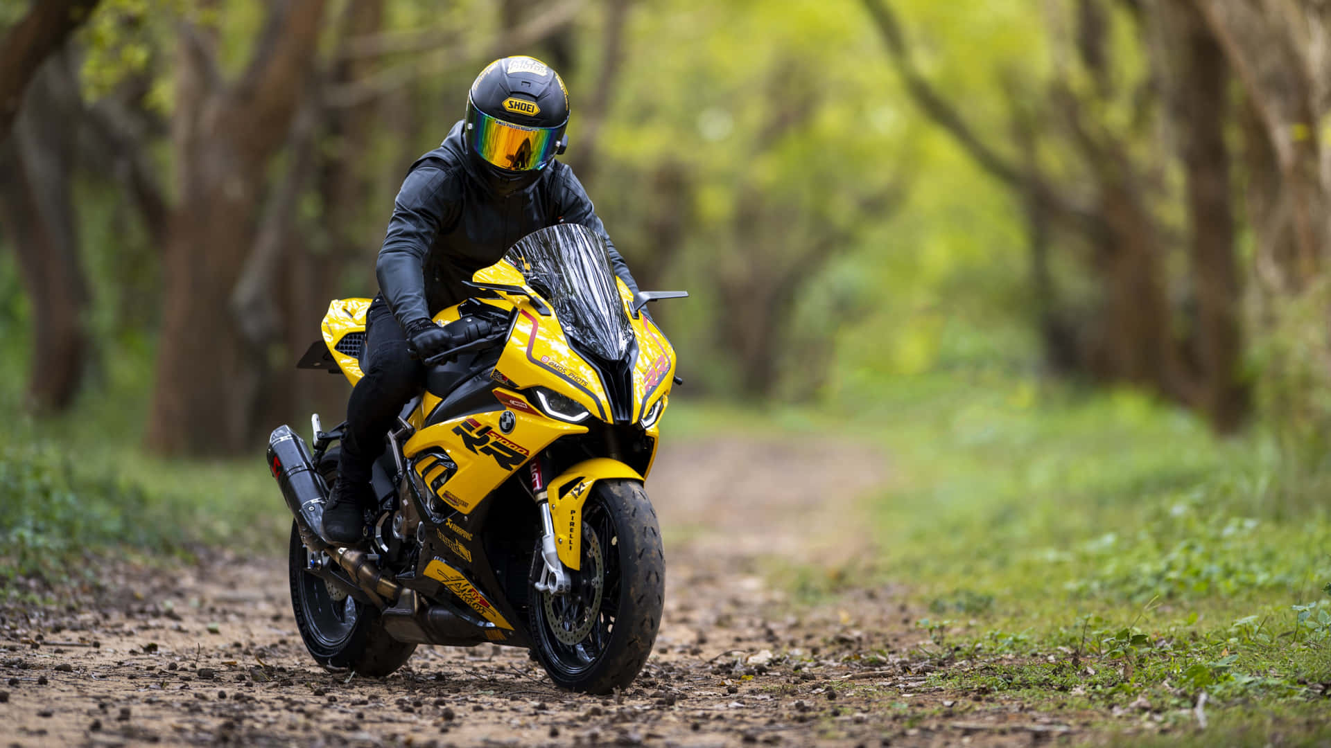 A Person Riding A Yellow Motorcycle Background