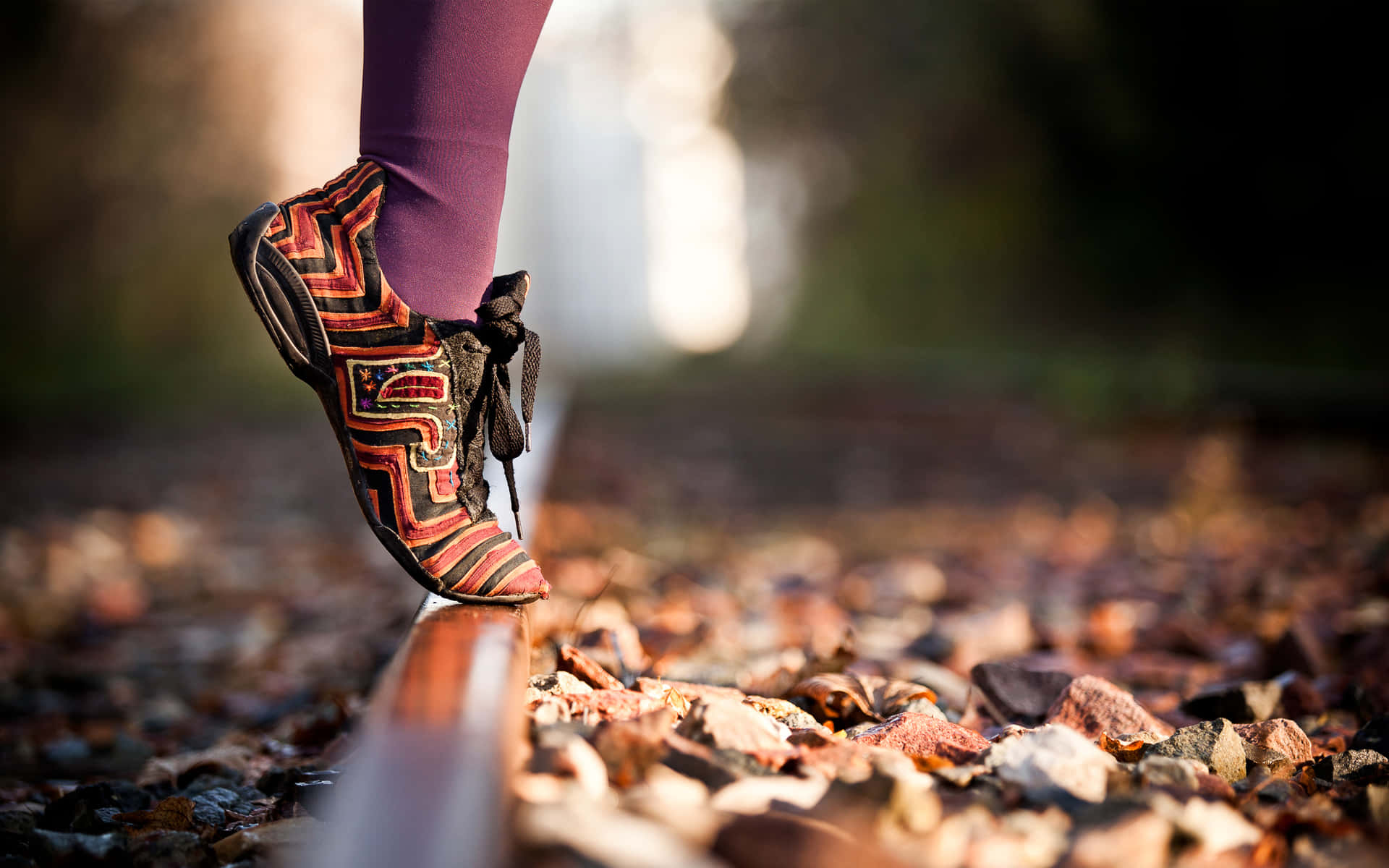A Person's Feet On A Rail Background