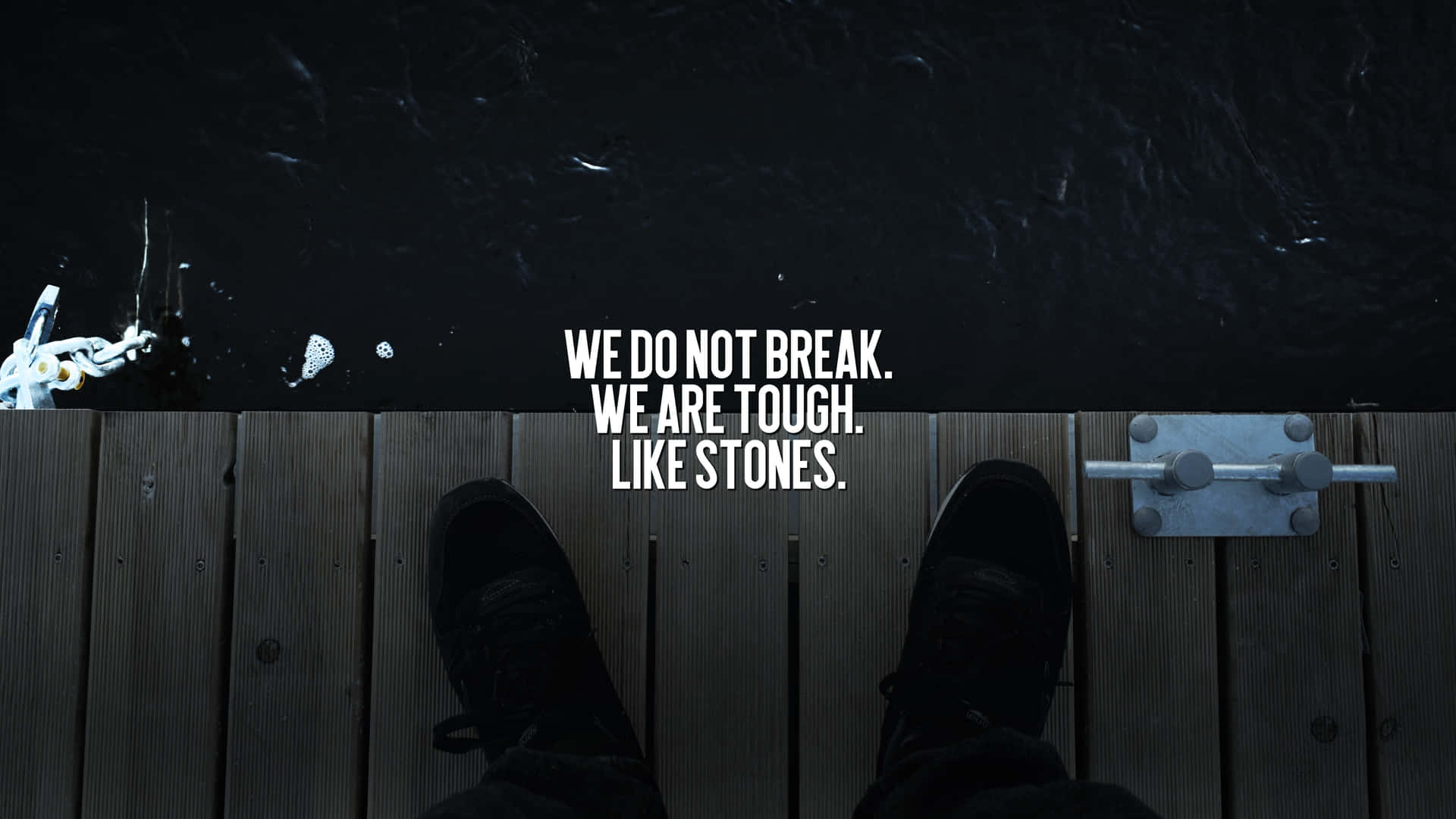 A Person Standing On A Dock With The Words We Don't Break We Are Tough Life's Stones