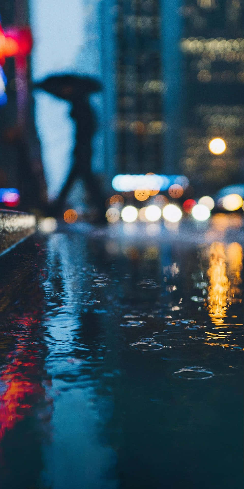 A Person Walking In The Rain Background