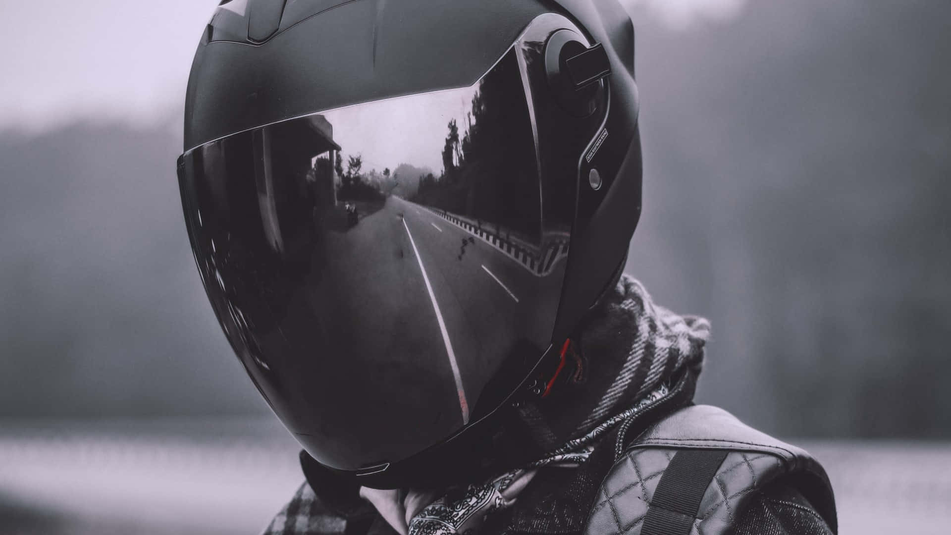 A Person Wearing A Helmet On A Road Background