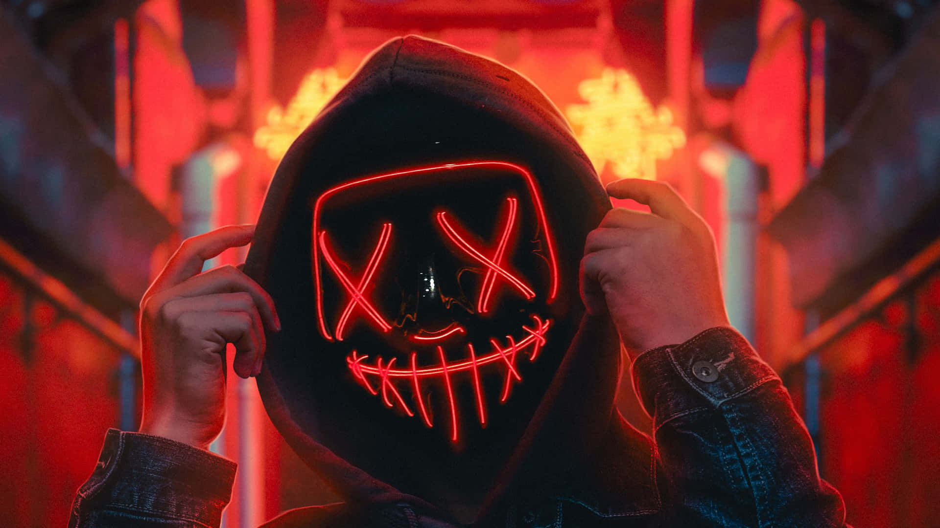 A Person Wearing A Neon Mask With A Hoodie Background