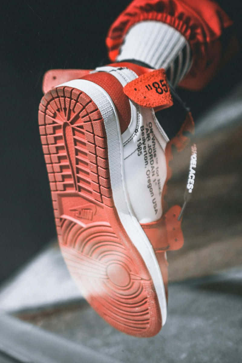A Person Wearing A Pair Of Sneakers On A Platform Background