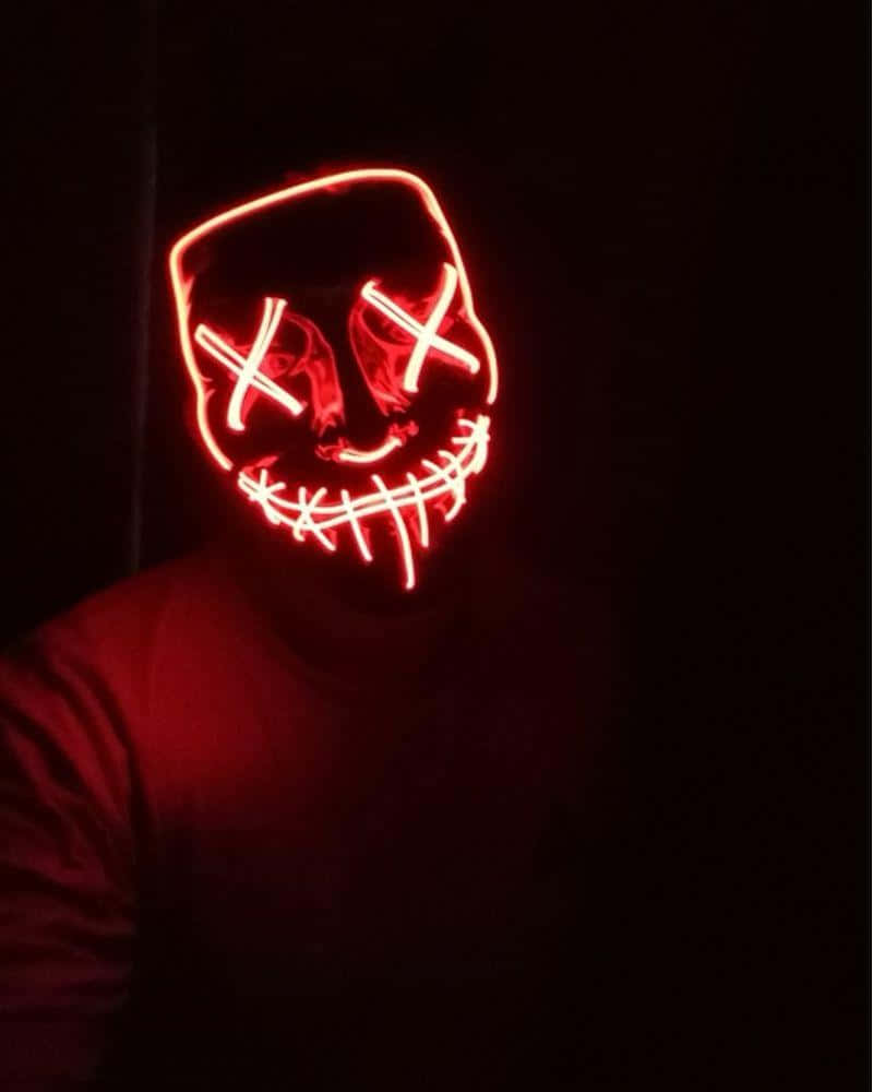 A Person Wearing A Red Led Mask In The Dark Background