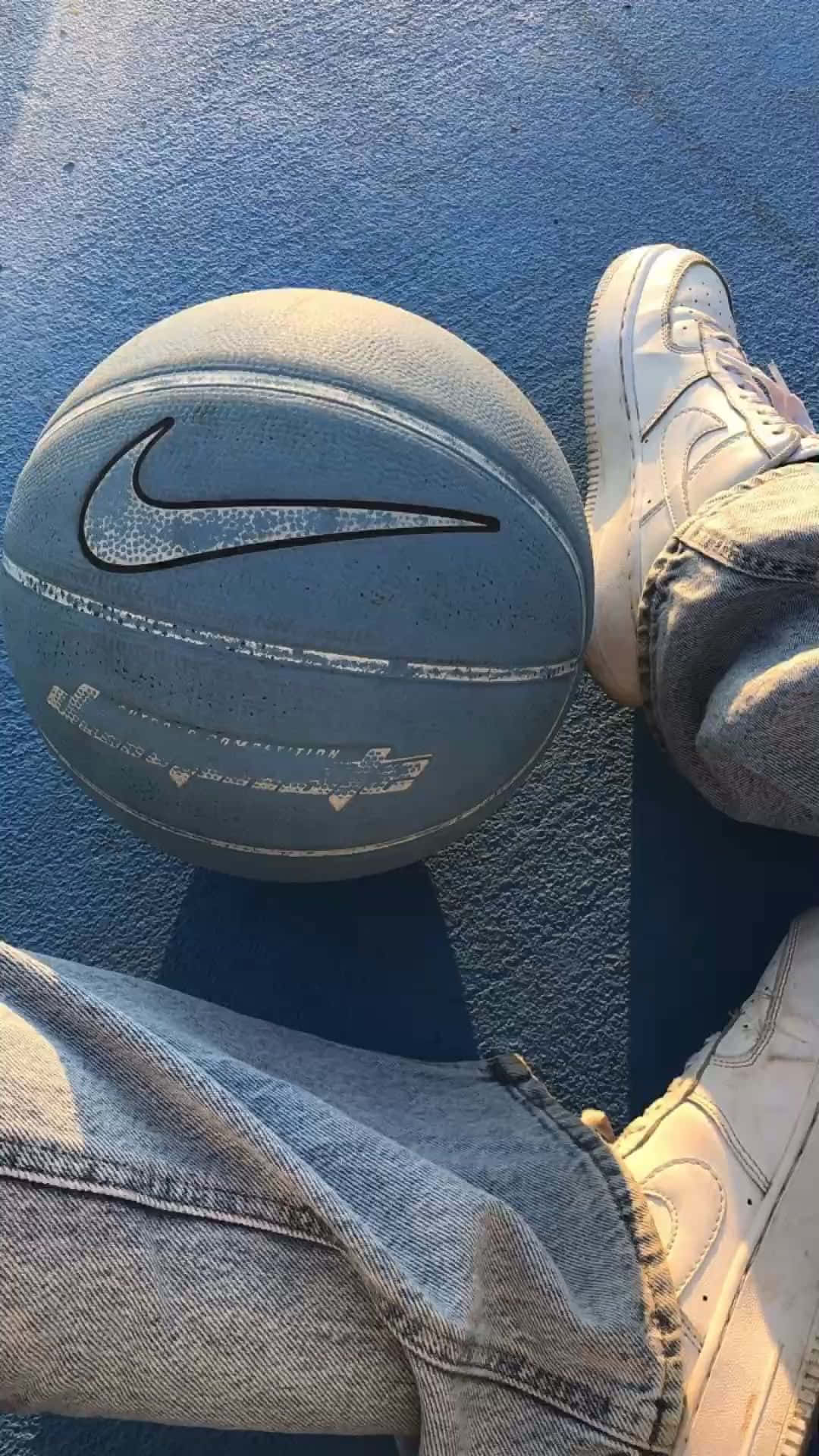 A Person Wearing Jeans And A Nike Ball