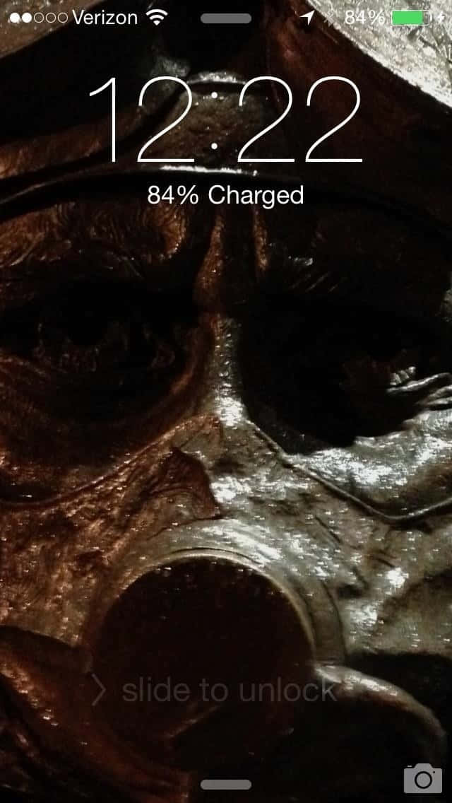 A Phone Screen Showing A Mask With A Skull Background