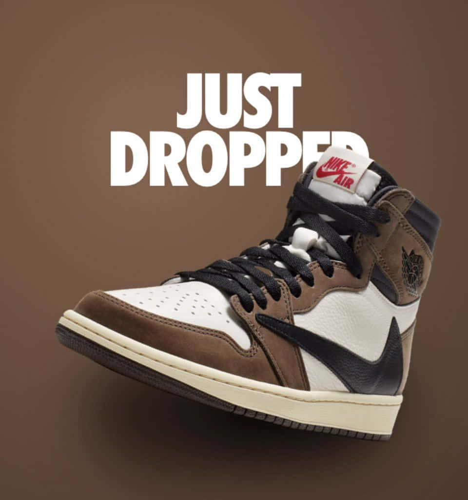 A Picture Of Travis Scott Wearing The Jordan 1 Sneakers Background