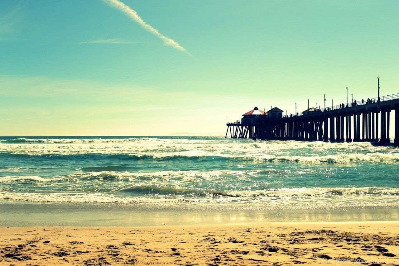 A Pier With A Car On The Beach