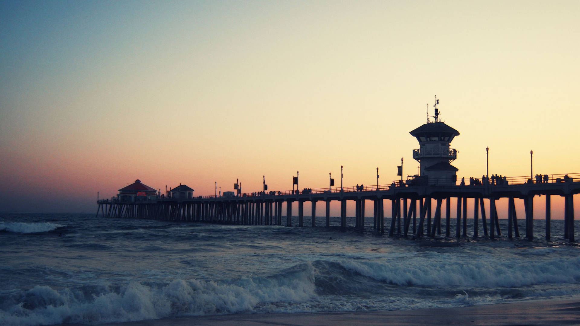 A Pier With A Lighthouse Background