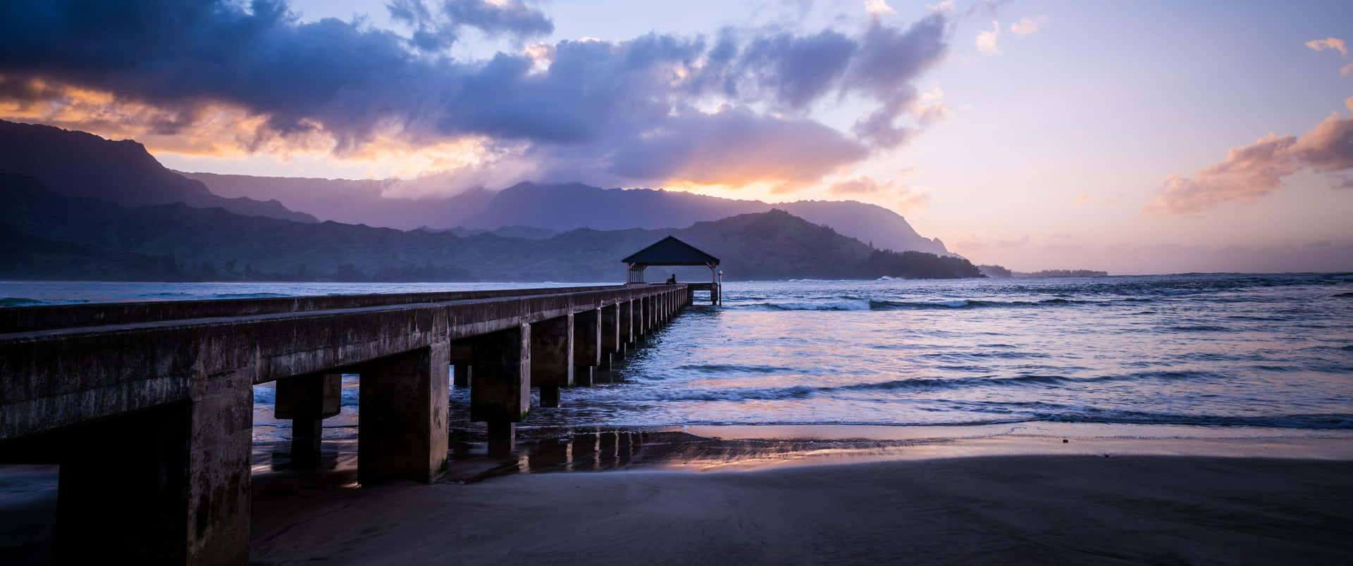 A Pier With A Sunset View Over The Ocean Background