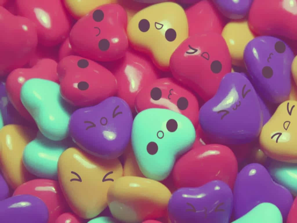 A Pile Of Colorful Candy Hearts With Faces