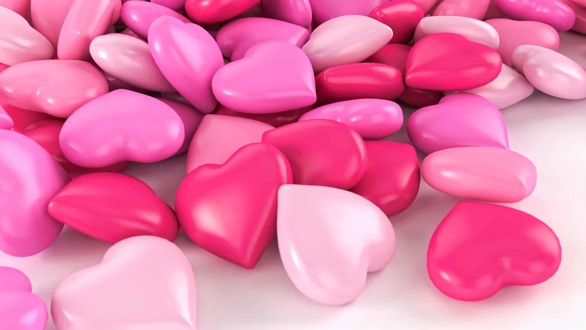 A Pile Of Pink And Pink Hearts On A White Surface