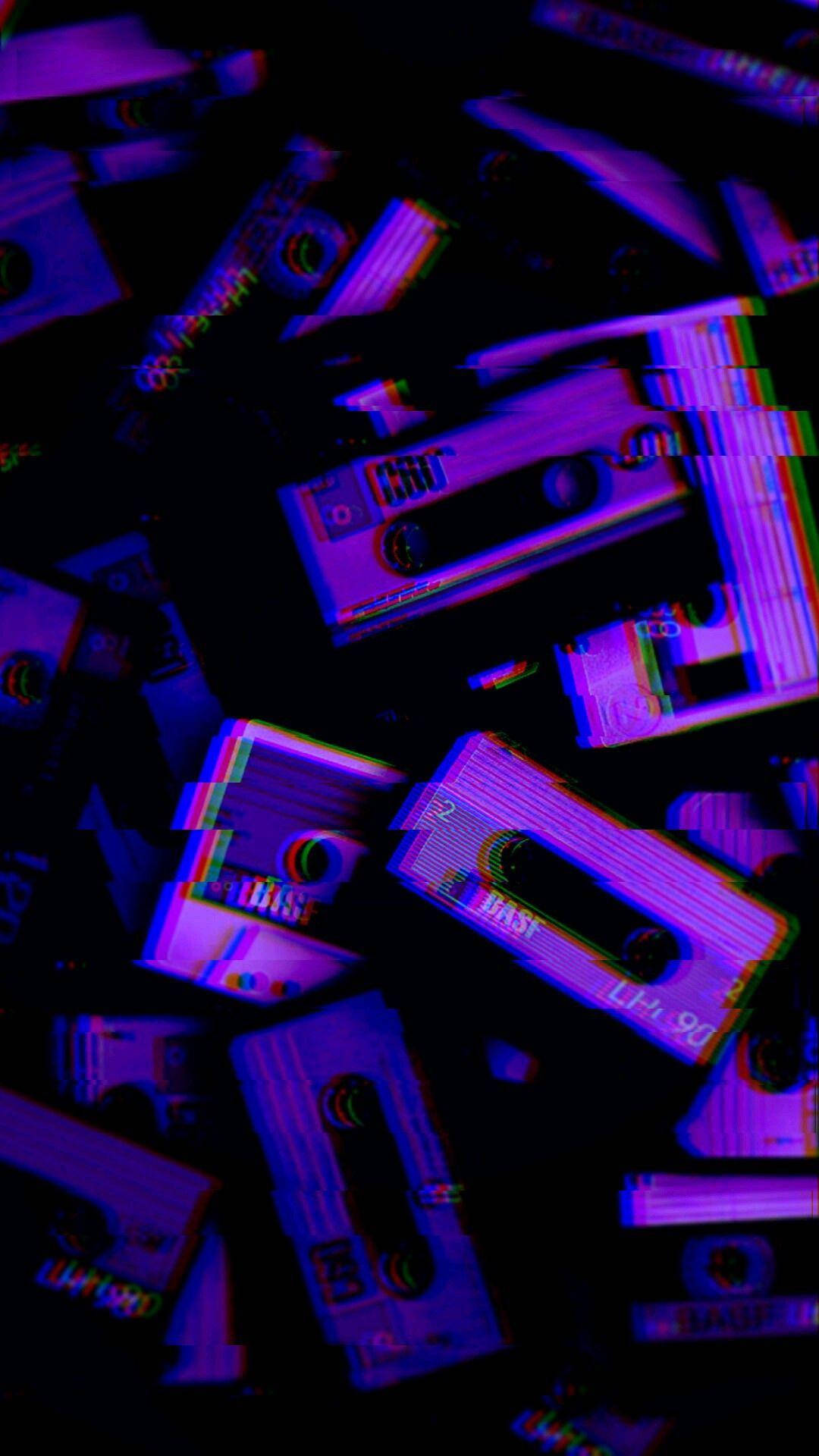 A Pile Of Purple And Blue Cassette Tapes Background