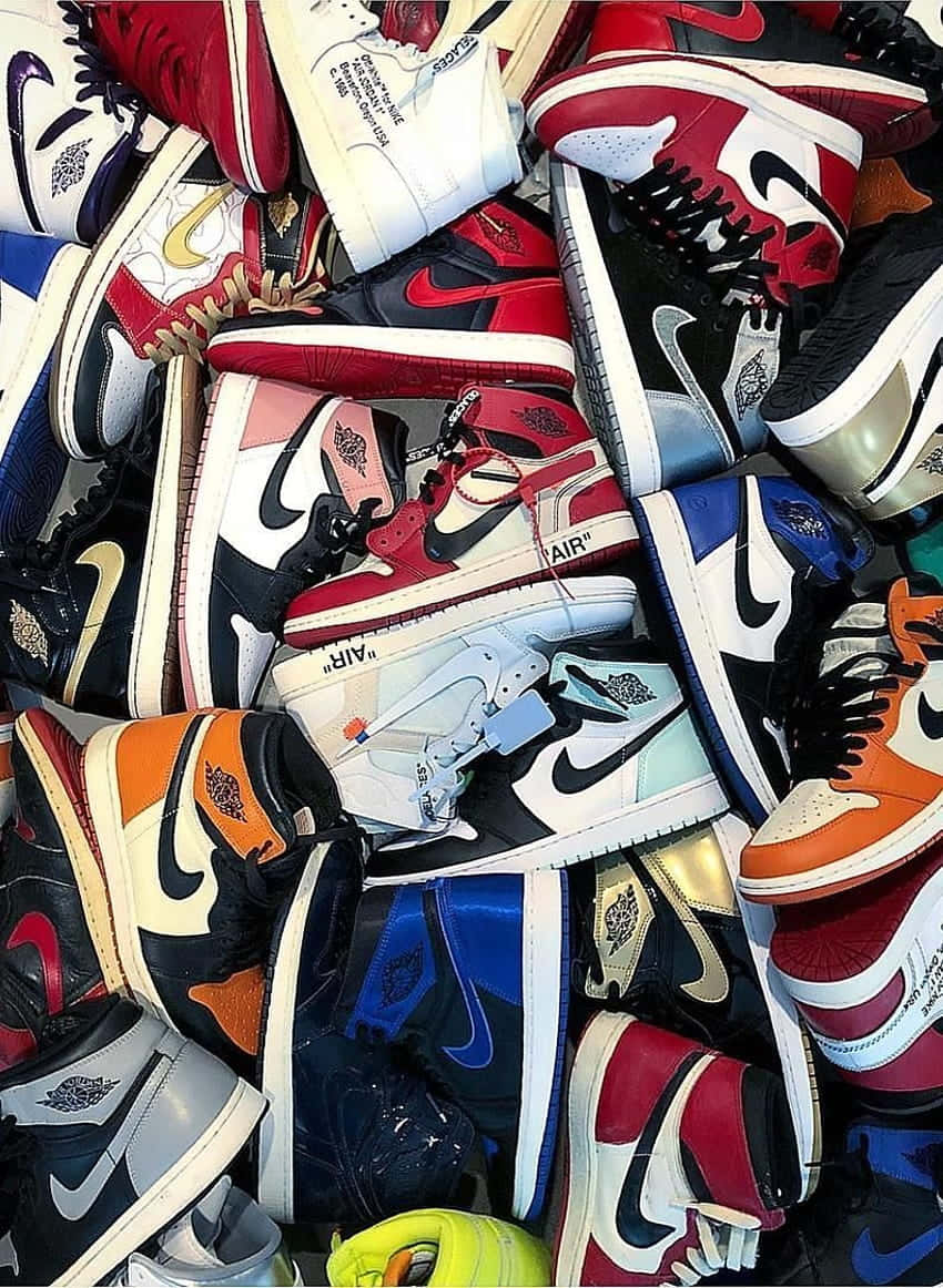 A Pile Of Sneakers Arranged In A Pile Background