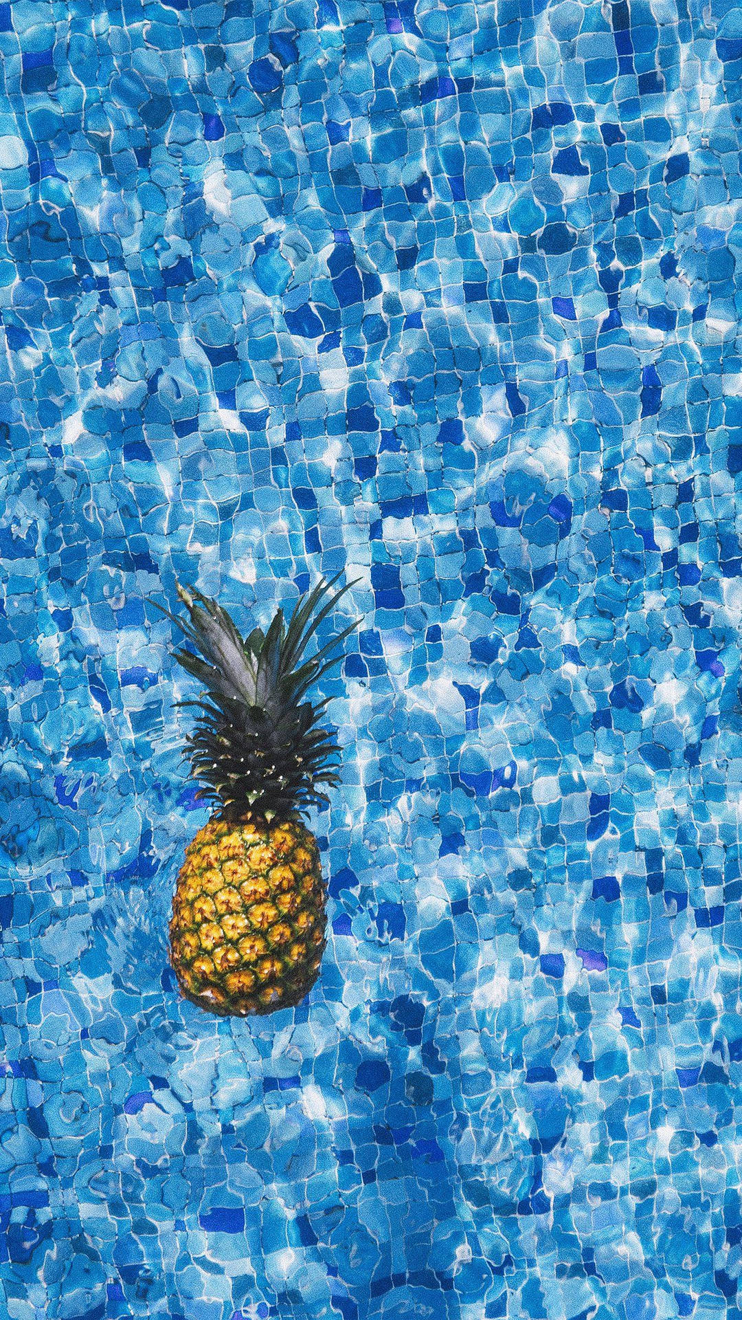 A Pineapple Floating In A Pool Background