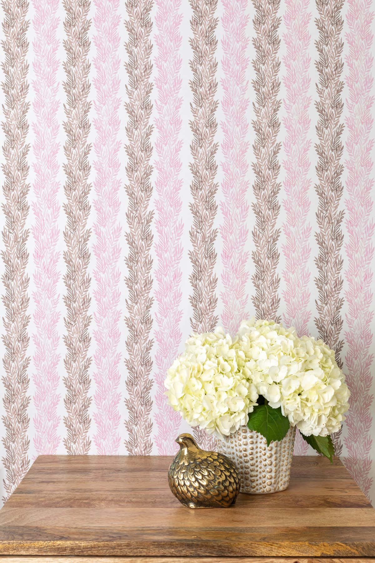 A Pink And Brown Wallpaper With A Vase Of Flowers Background