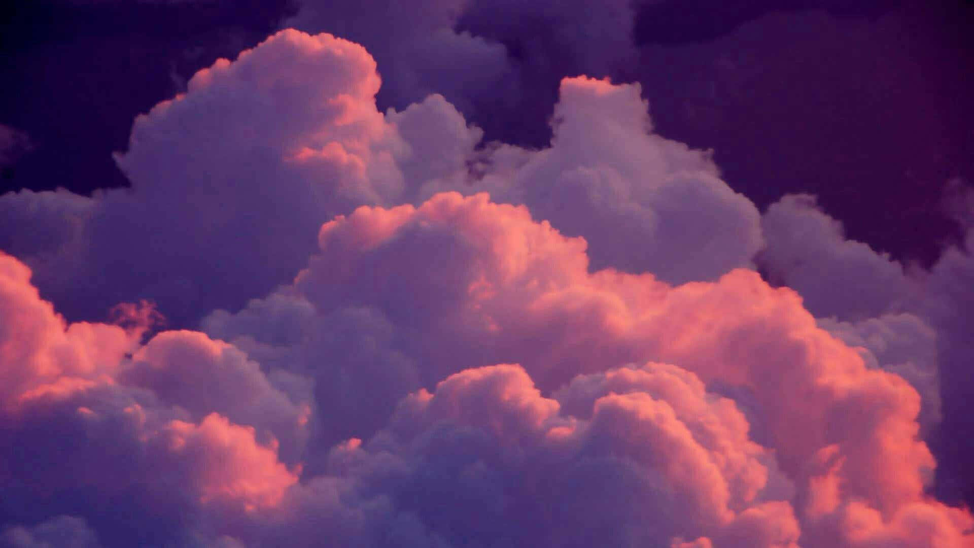 A Pink And Purple Sky With Clouds