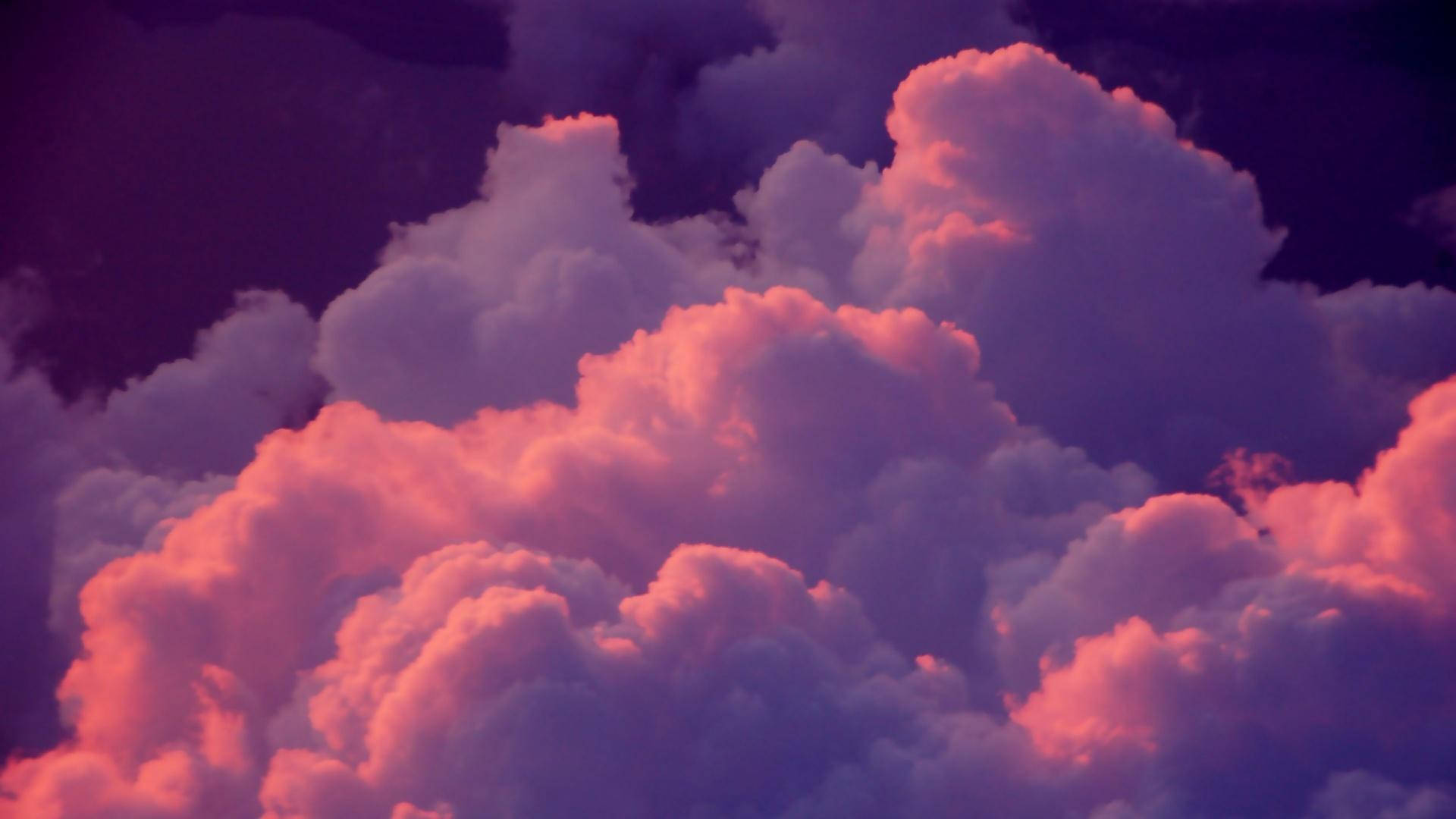 A Pink And Purple Sky With Clouds Background