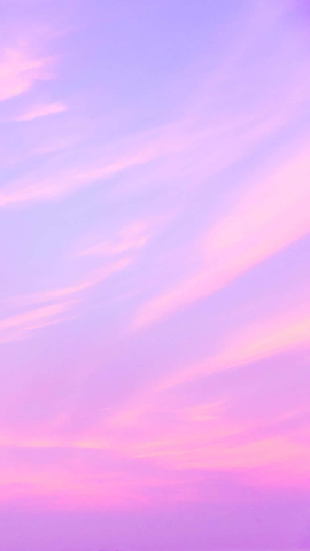 A Pink And Purple Sky With Clouds