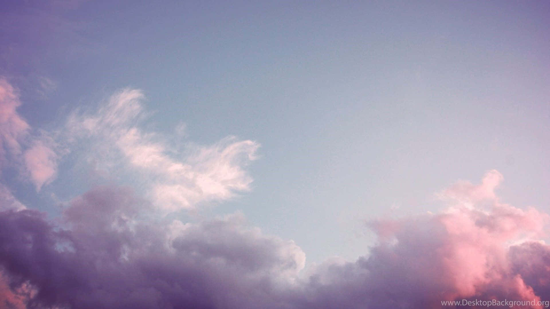 A Pink And Purple Sky With Clouds
