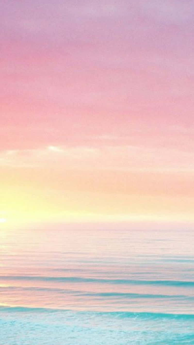 A Pink And Purple Sunset Over The Ocean Background