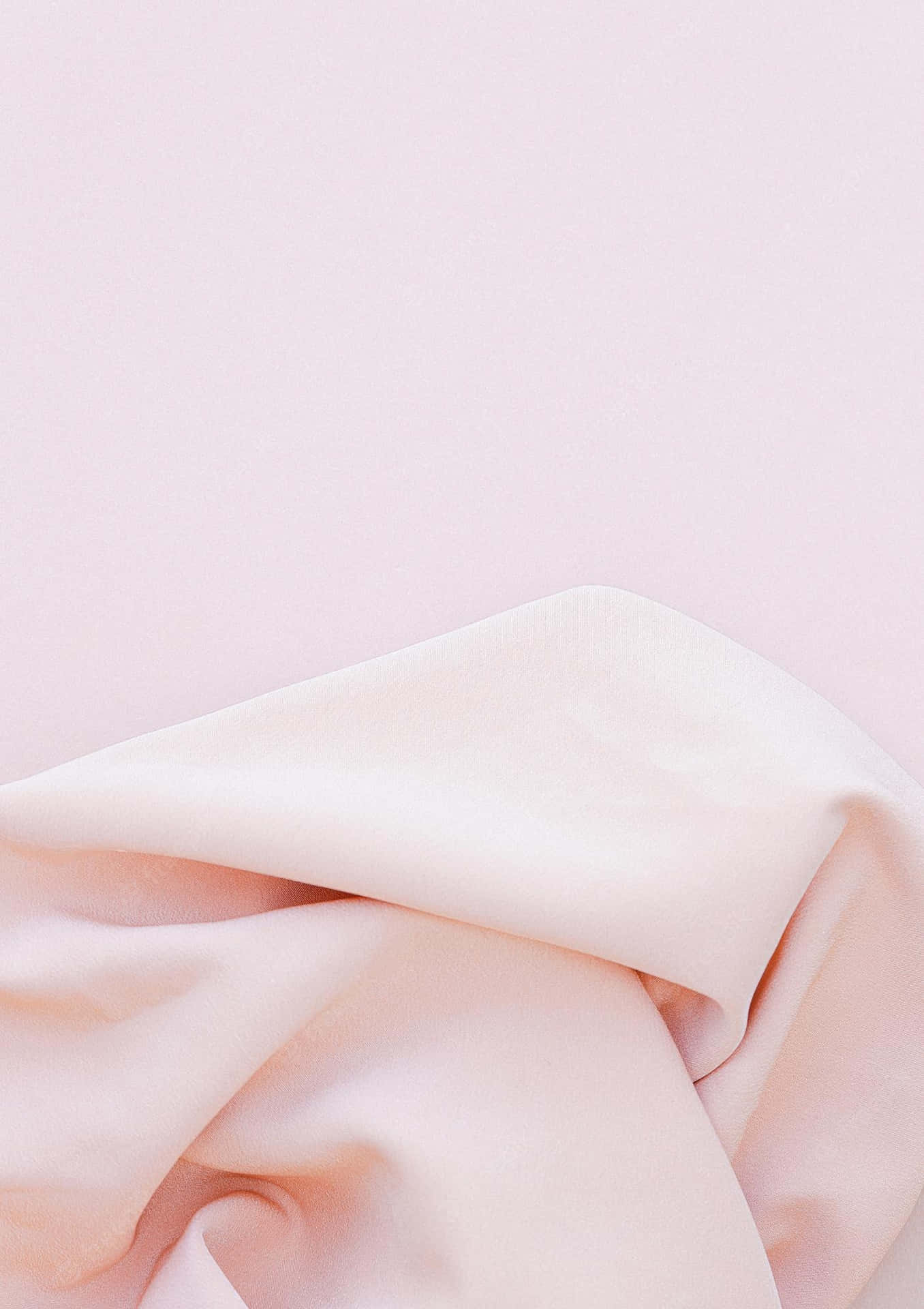 A Pink Blanket On A White Surface Background