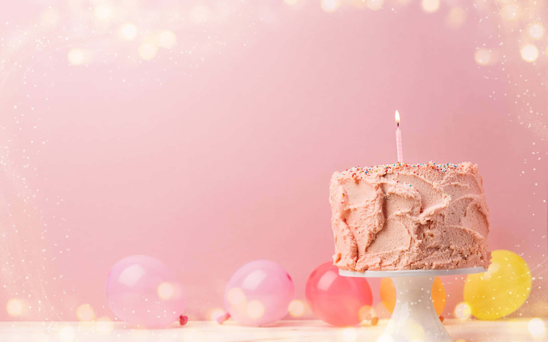 A Pink Cake On A White Plate With Balloons On A Pink Background Background