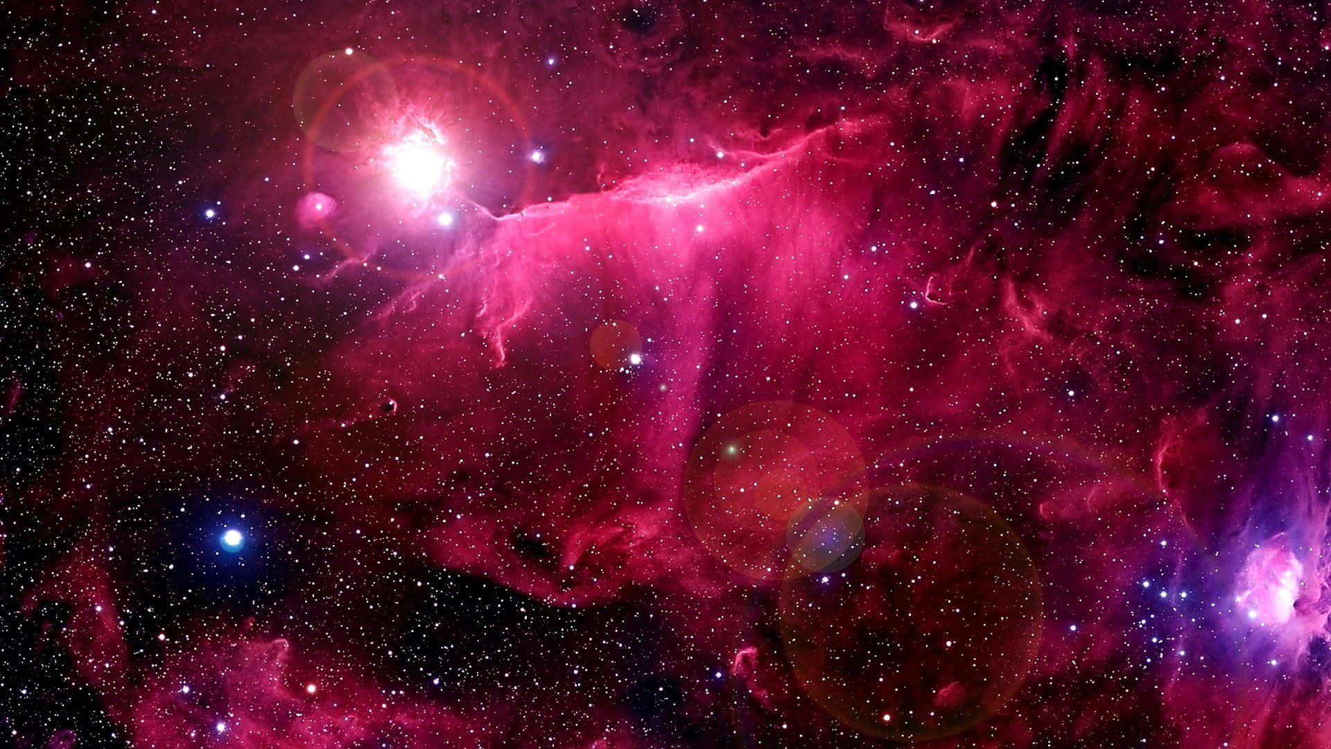 A Pink Nebula With Stars And Stars