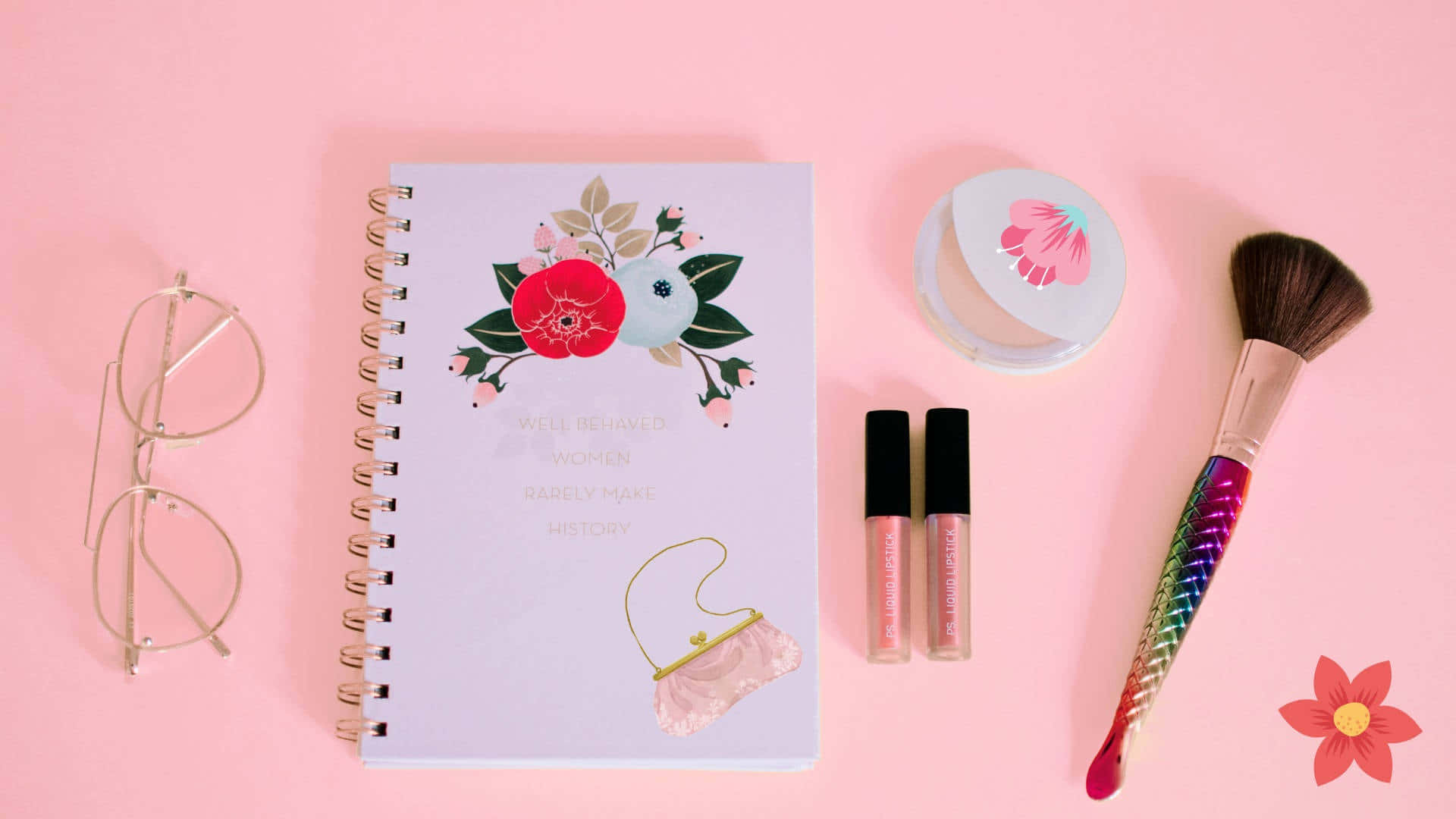 A Pink Notebook With Makeup Products And Eyeglasses Background