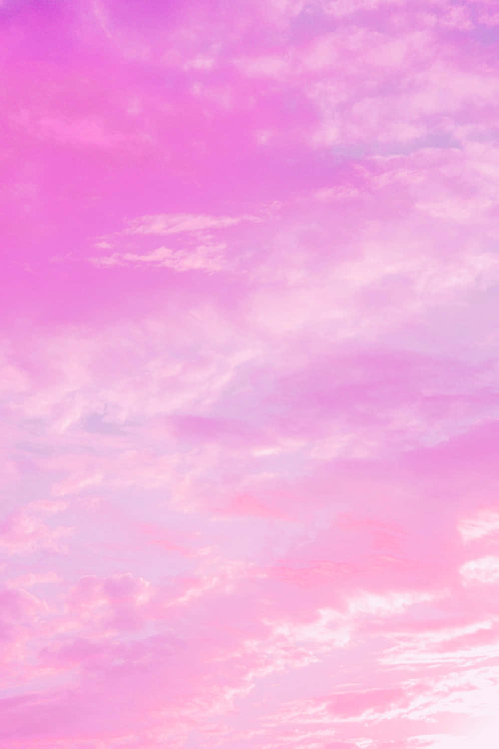A Pink Sky With Clouds In The Background Background
