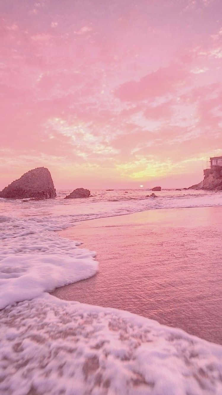 A Pink Sunset With Waves On The Beach Background