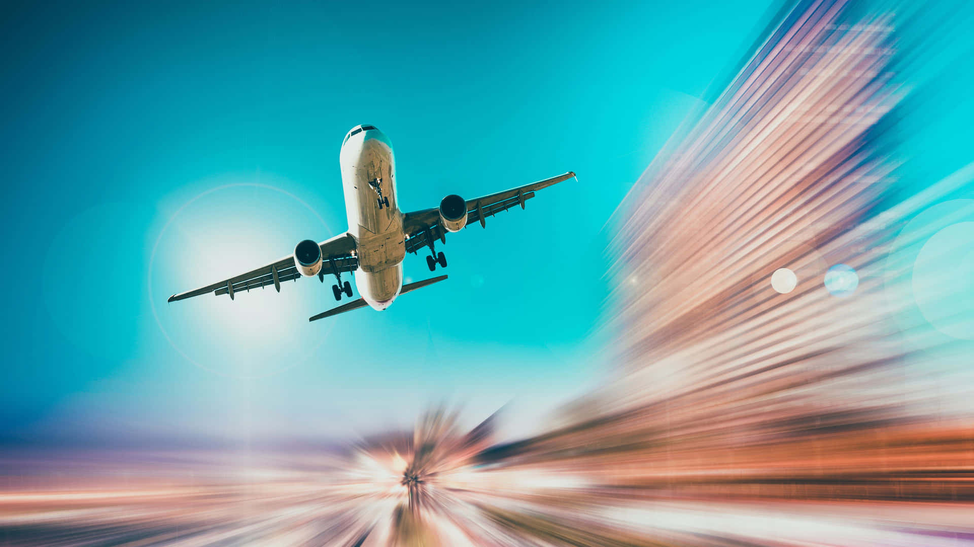 A Plane Flying Over A City With Blurred Background Background