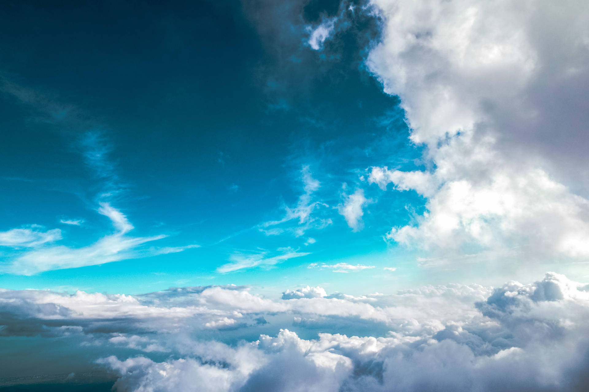 A Plane Flying Over Clouds Background