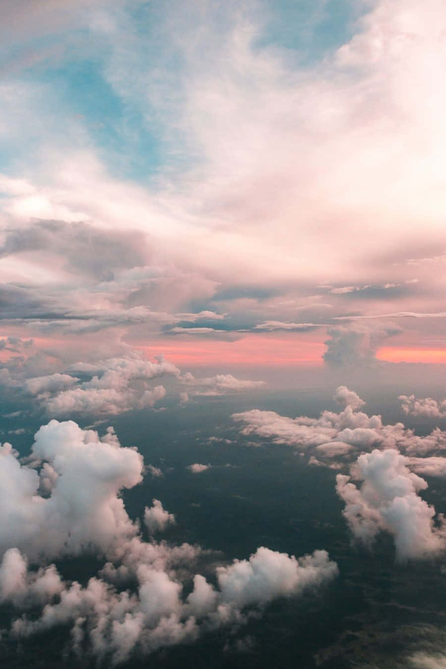 A Plane Flying Over The Clouds Background