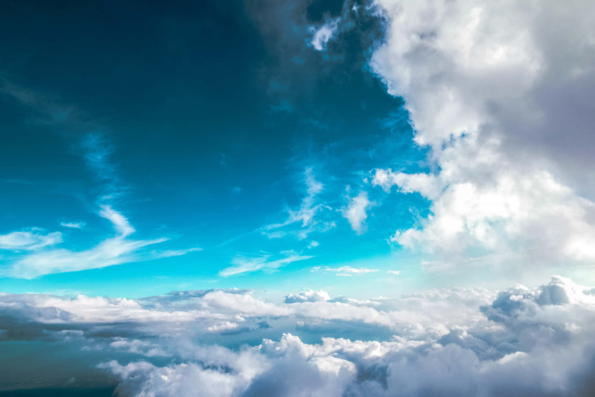 A Plane Flying Over The Clouds Background