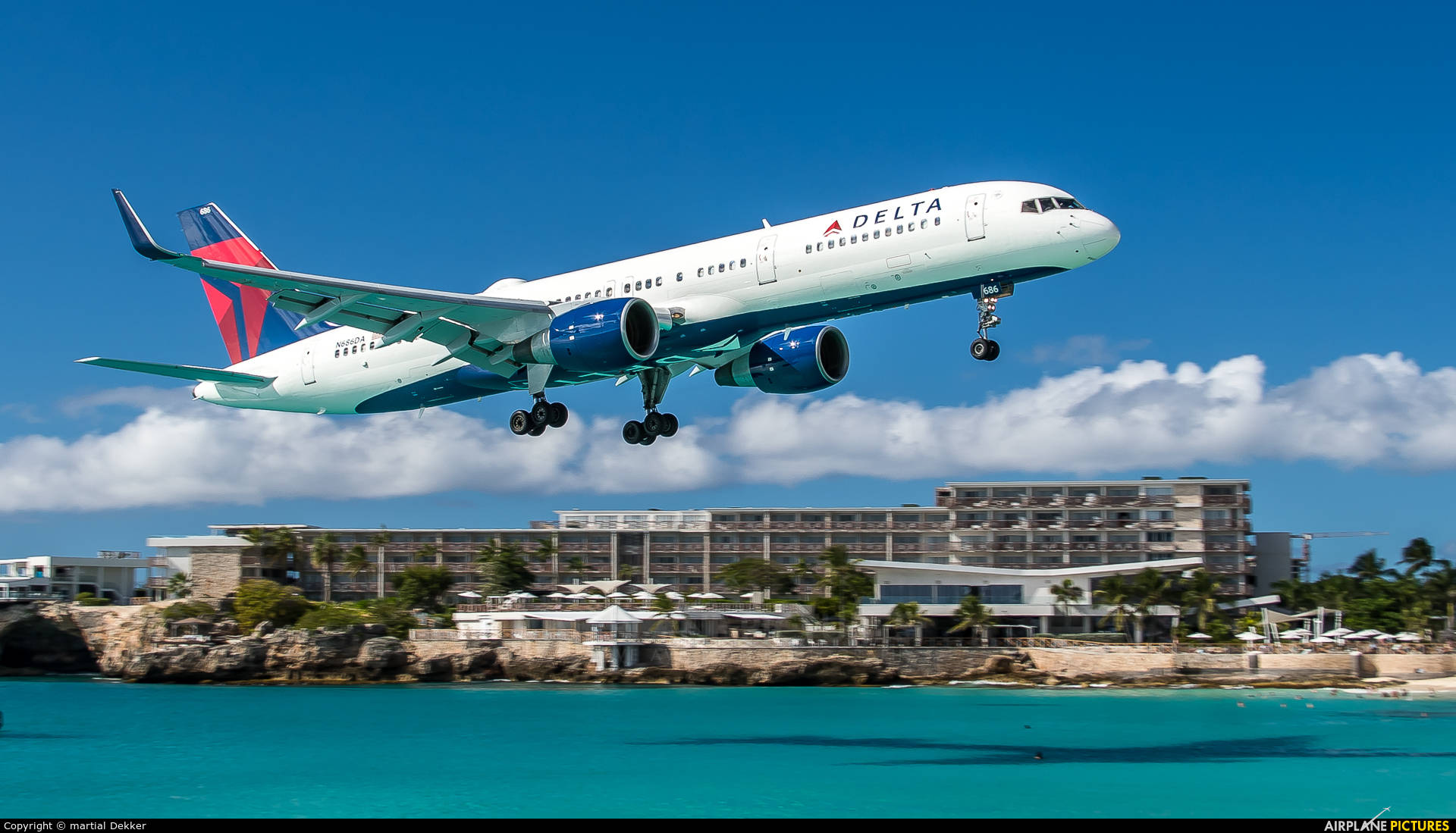 A Plane Landing At Sint Maarten Airport Background