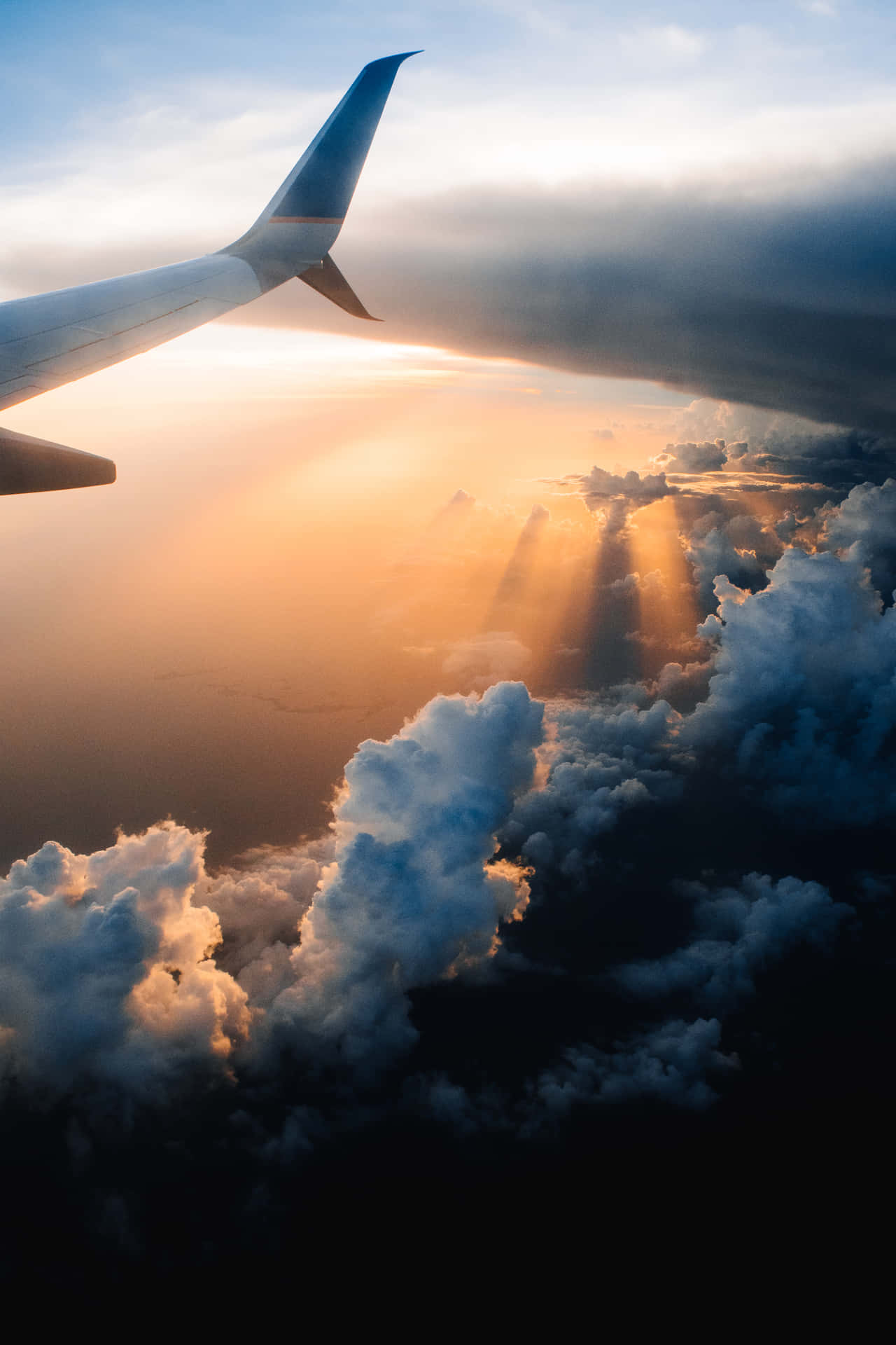 A Plane Wing Flying Over Clouds Background