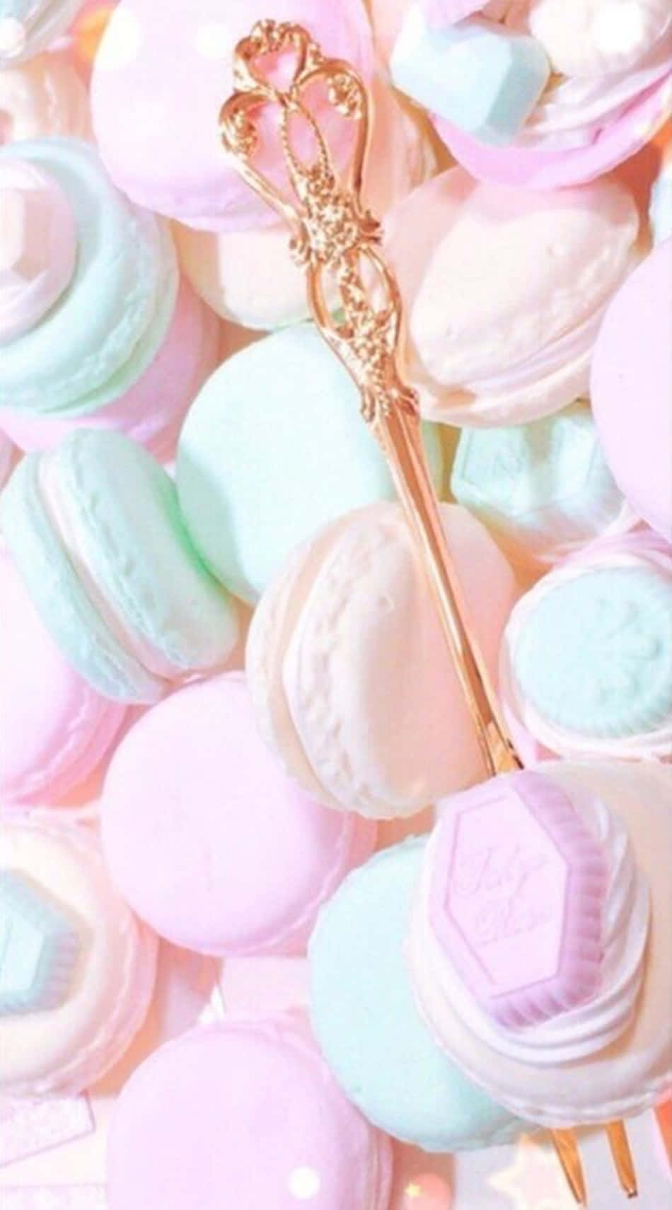 A Plate Of Macarons With A Gold Fork Background