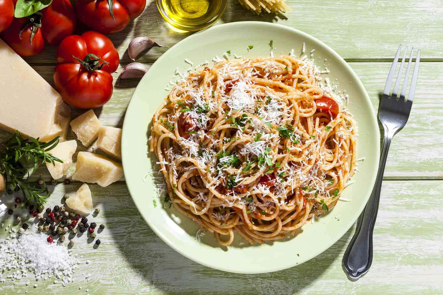 A Plate Of Spaghetti With Tomatoes, Parmesan Cheese And Other Ingredients Background