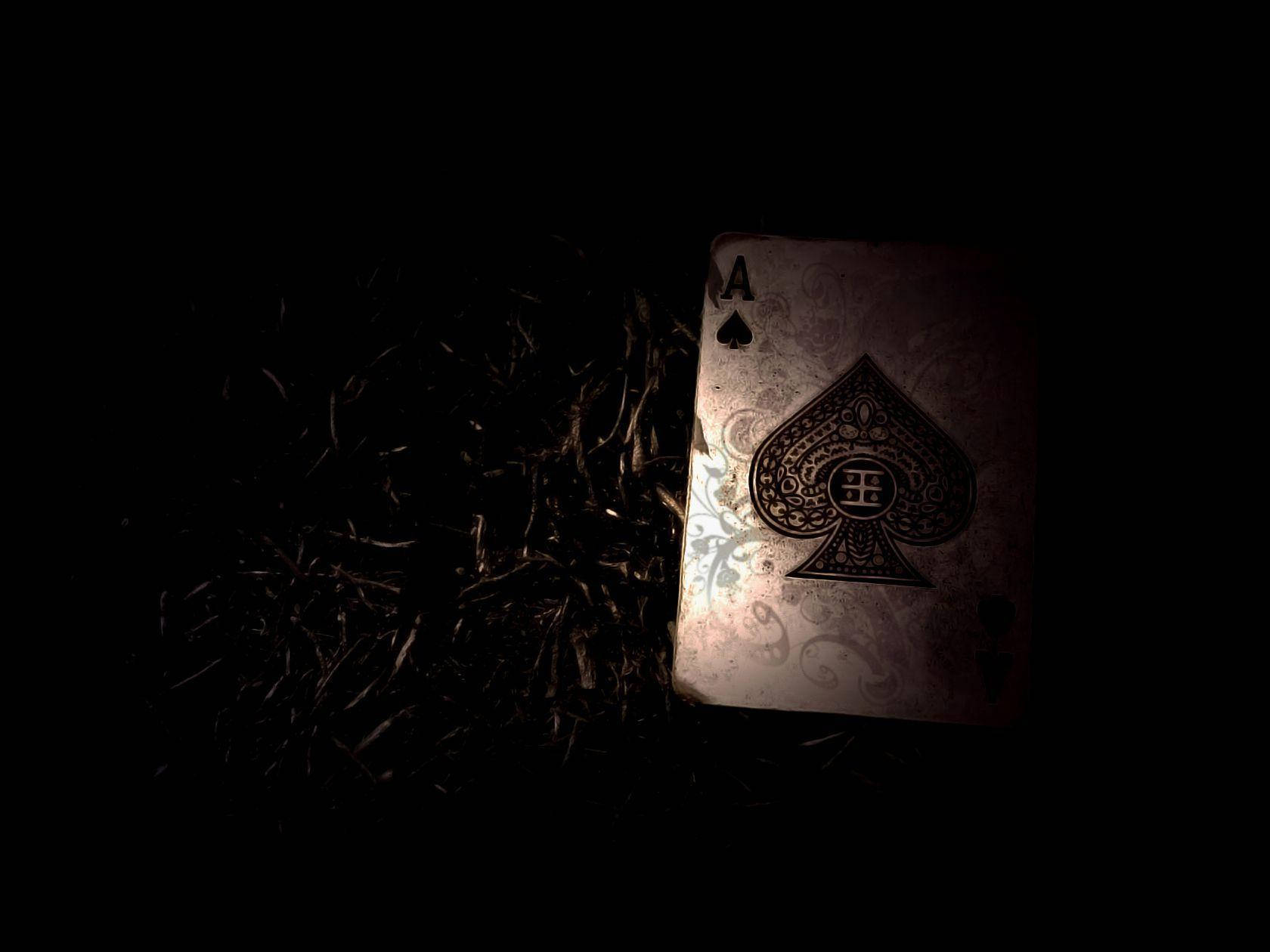 A Playing Card Is Sitting On The Ground In The Dark