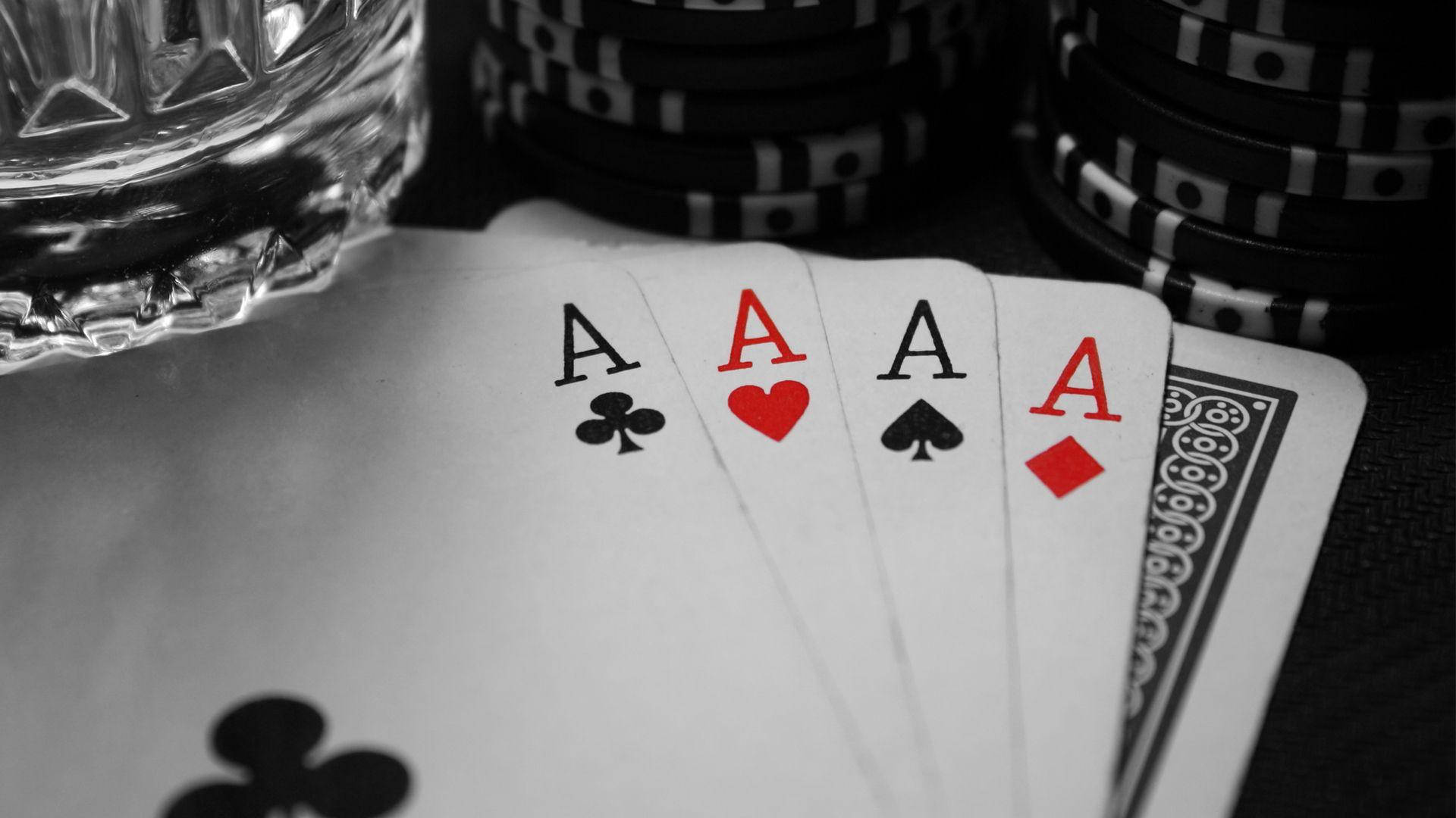 A Poker Table With A Glass Of Water And Cards Background