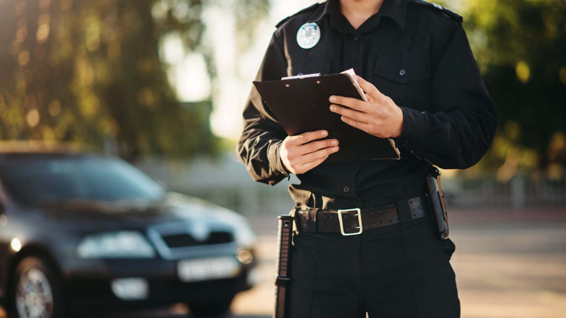 A Police Officer Stands Confidently And Proudly In Uniform Background