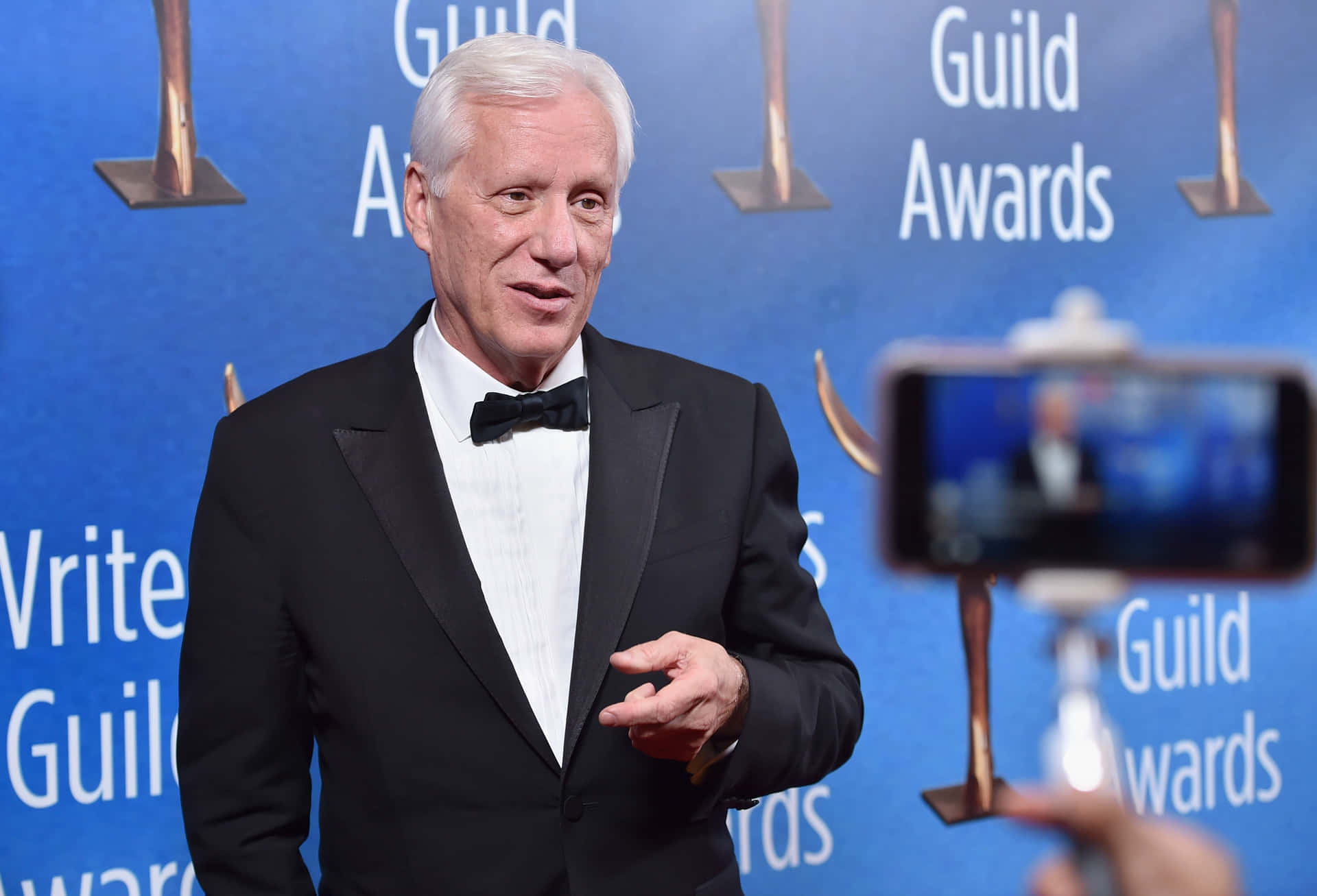 A Polished Portrait Of Esteemed Actor James Woods. Background