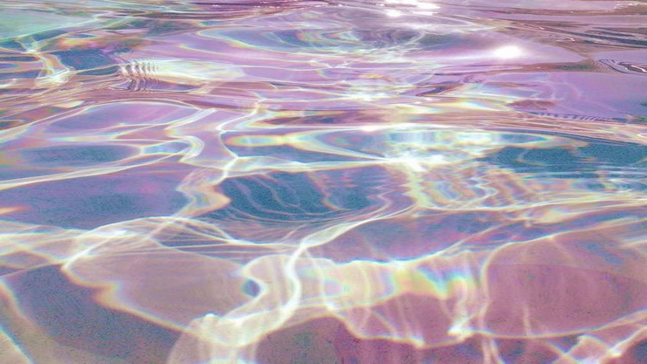 A Pool With A Rainbow Colored Water Background