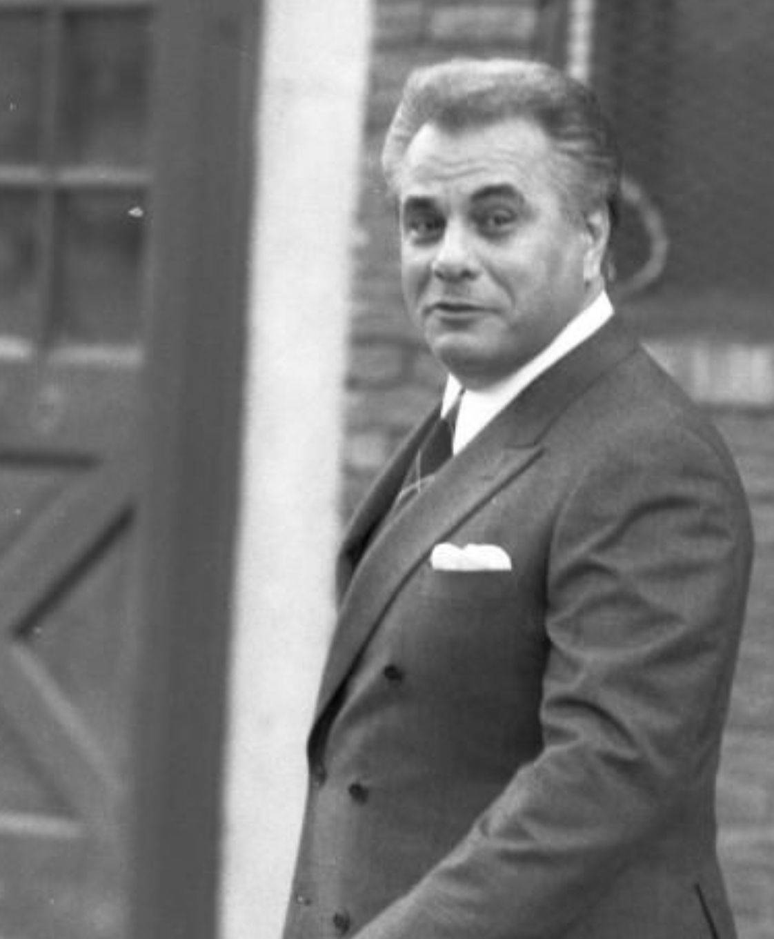 A Powerful Gaze From The Notorious John Gotti In Monochrome Background